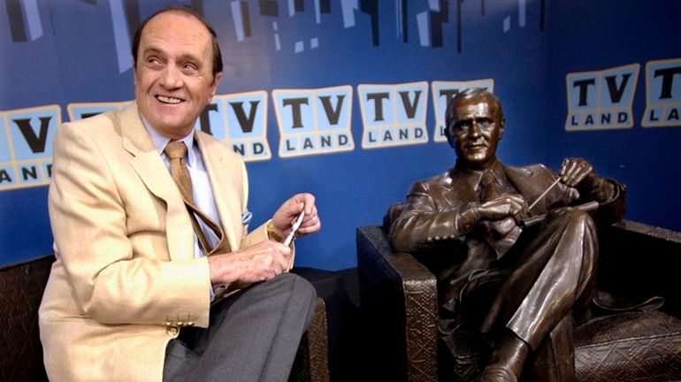 Bob Newhart sits with a bronze likeness of Dr. Bob...