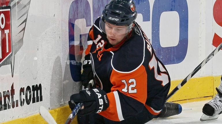 The Islanders' Josh Bailey controls the puck after being knocked...