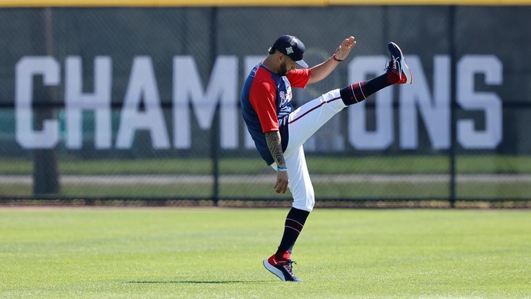 Atlanta Braves outfielder Eddie Rosario loosens up as he arrives...