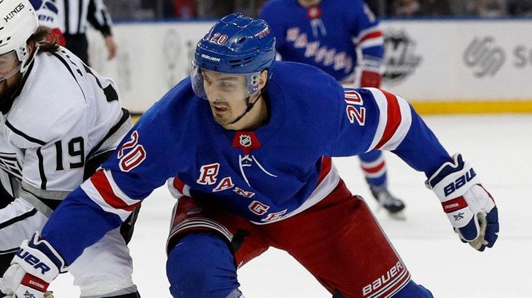 Chris Kreider of the Rangers battles for the puck during...