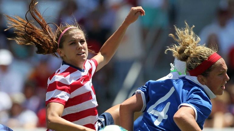 USA forward Alex Morgan, left, and Canada defender Carmelina Moscato...