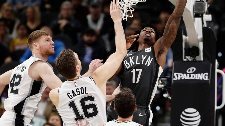 Nets forward Ed Davis shoots past San Antonio Spurs forward...