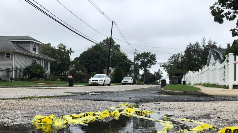 Crime scene tape on Parsons Avenue in Freeport, where police...