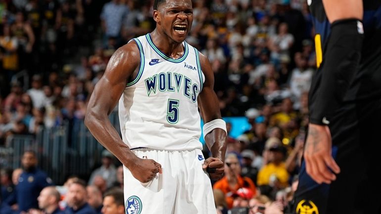 Minnesota Timberwolves guard Anthony Edwards reacts after hitting a basket...