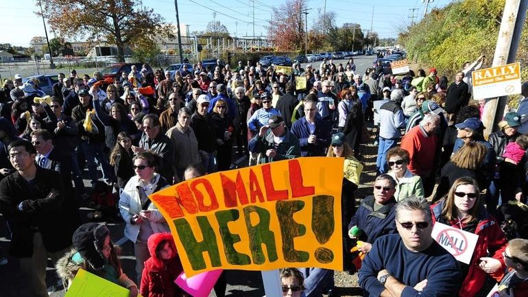 Syosset residents rally to protest the Taubman company's continued efforts...