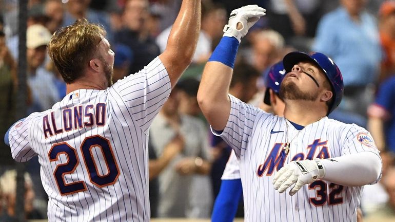 Mets designated hitter Daniel Vogelbach is greeted by Pete Alonso...