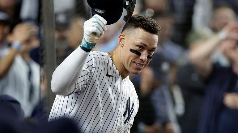 Aaron Judge of the Yankees acknowledges a curtain call after his seventh-inning...