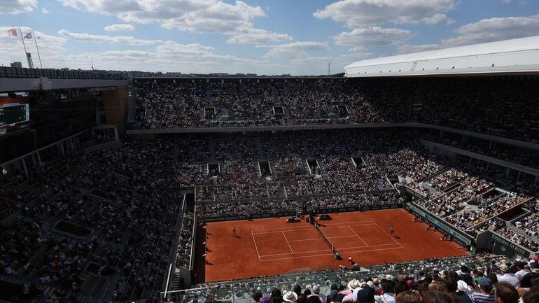 Germany's Alexander Zverev, right, serves against Spain's Carlos Alcaraz during...