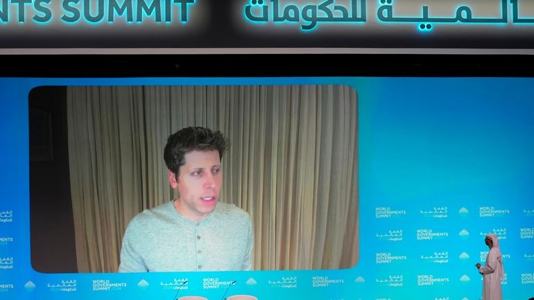 OpenAI CEO Sam Altman talks on a video chat during...