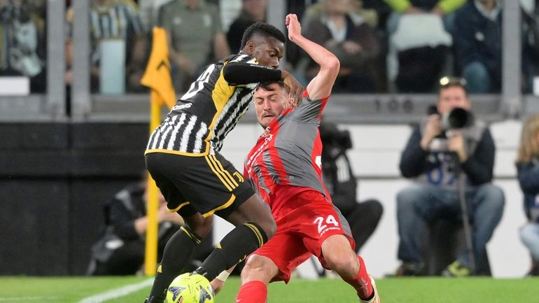 Juventus' Paul Pogba, left, in action against Cremonese's Ferrari during...