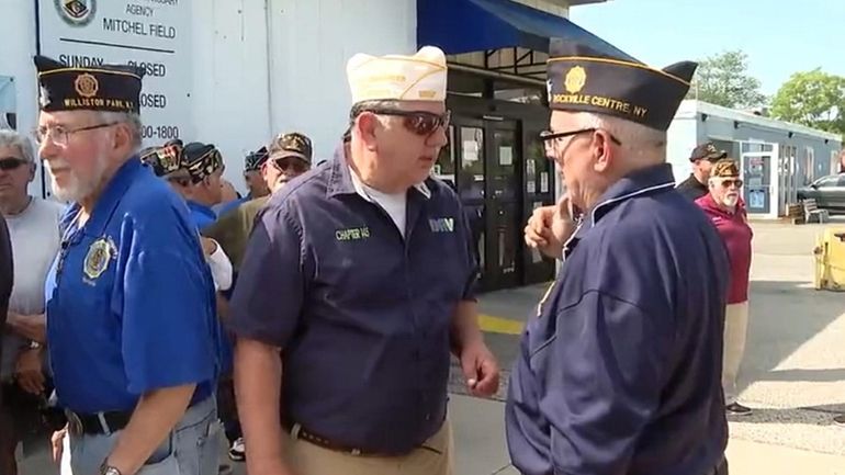 Veterans gather at the shuttered Mitchel Field commissary on Wednesday.