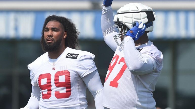 Leonard Williams, left, stands alongside Dexter Lawrence II during the...