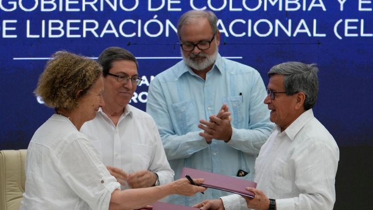 Colombian government representative Vera Grabe, left, and Colombian commander of...