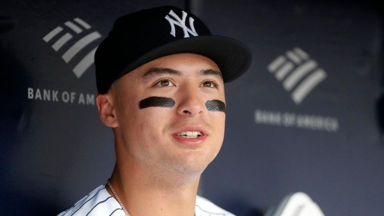 Anthony Volpe #11 of the New York Yankees looks on...