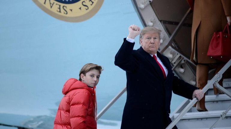 President Donald Trump boarding Air Force One with his son...