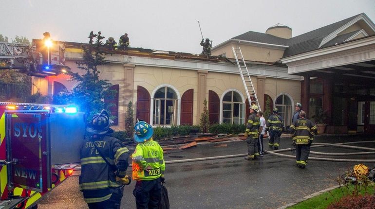 Firefighters at the North Ritz Club in Syosset, where a...