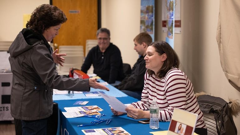 Rosemaria Stocks, left, of Bay Shore speaks with Valerie Azic of...