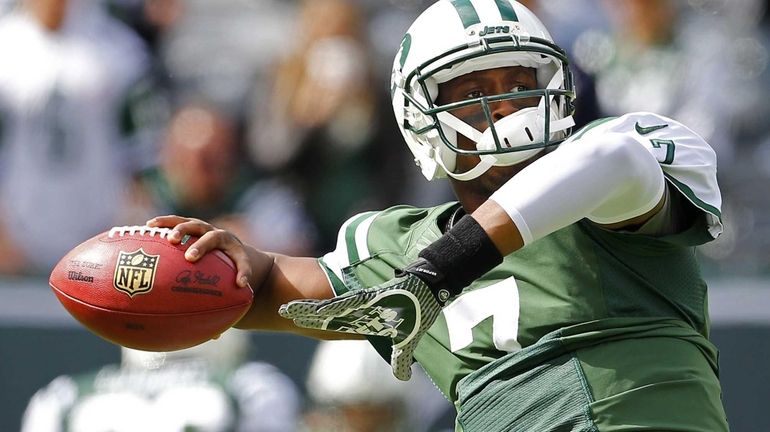 Geno Smith passes during a pregame drill before the start...