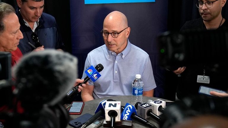 Yankees general manager Brian Cashman speaks to reporters during a...