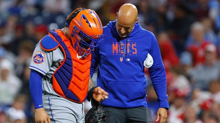 Catcher Francisco Alvarez #4 of the Mets walks off the field...