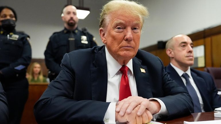 Former President Donald Trump waits for the start of proceedings...