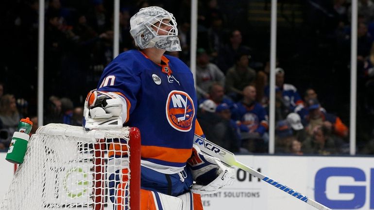 Robin Lehner of the Islanders looks on after surrendering a...