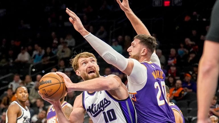 Sacramento Kings' Domantas Sabonis (10) looks to shoot against Phoenix...