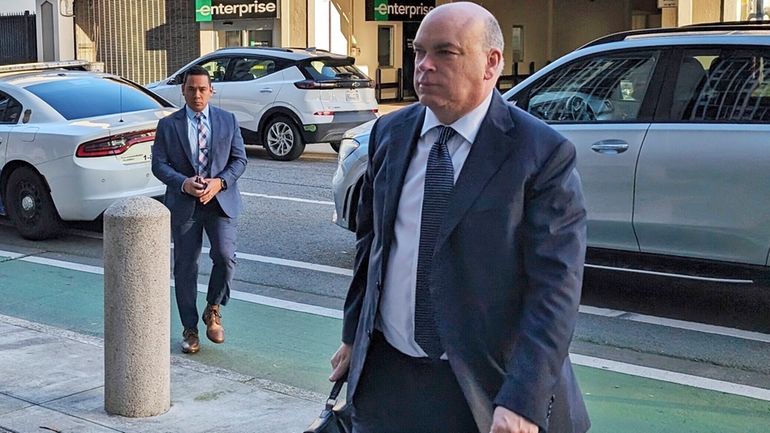 British tech magnate Mike Lynch walks into federal court in...