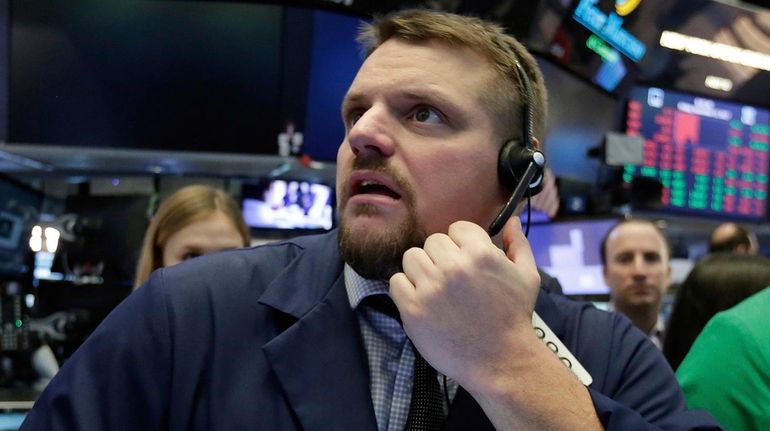 Trader Michael Milano works on the floor of the NYSE,...