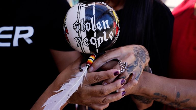 Grassroots advocates hold a Native American gourd rattle at Drumbeat...