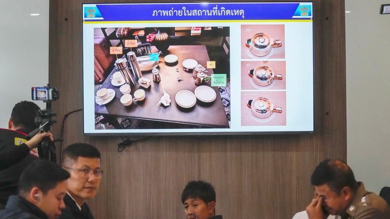 Thai police display pictures of evidence during a press conference...