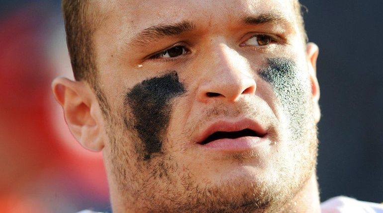 Defensive end Mike Catapano watches from the sidelines while with...