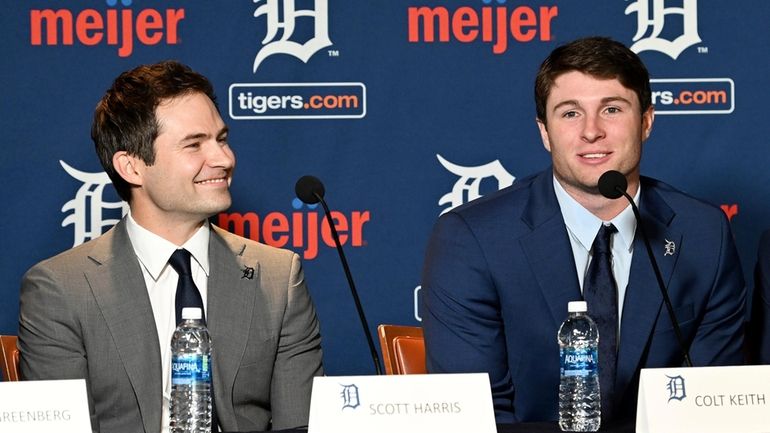 Detroit Tigers president of baseball operations Scott Harris, left, listens...