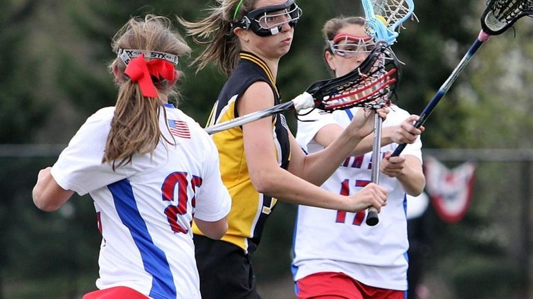 Wantagh's Paula Schmidt gets between South Side defenders during a...