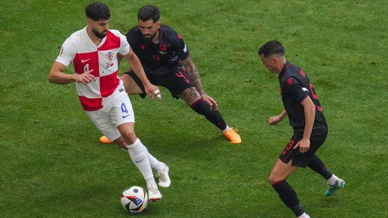 Croatia's Josko Gvardiol, left, challenges for the ball with Albania's...