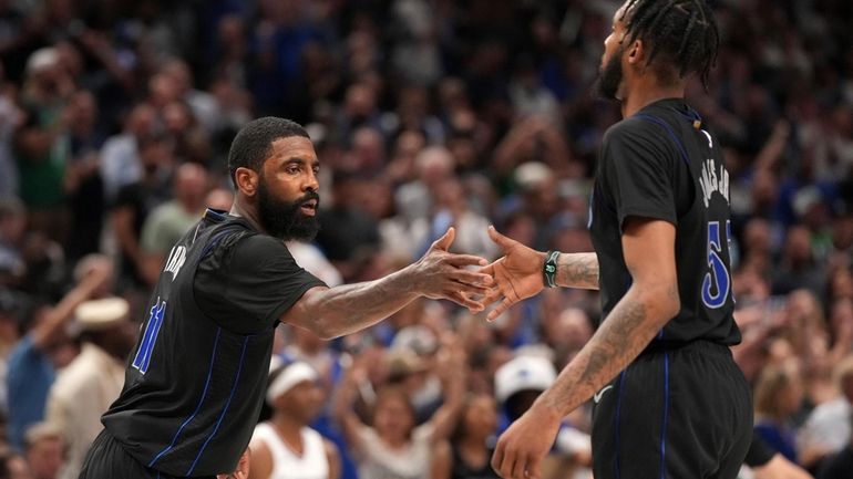 Dallas Mavericks guard Kyrie Irving (11) congratulates forward Derrick Jones...