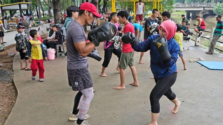 Rani Miranti, right, practices martial arts with Rizal Zulmi, a...