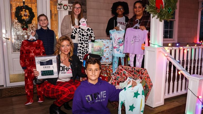 Patricia Poggi, kneeling left,  who is heading up a pajama-donation...