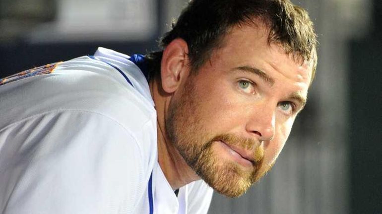 Mets starting pitcher Mike Pelfrey sits in the dugout after...