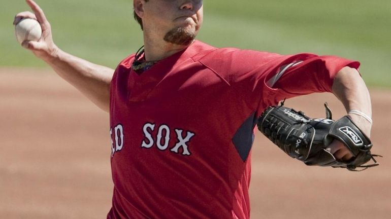 Boston Red Sox starting pitcher Josh Beckett works against the...