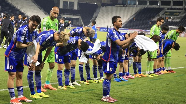 Japan's players celebrate after U-23 Asian Cup semi-final match between...