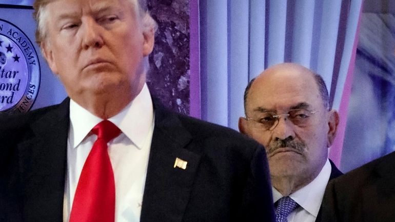 Allen Weisselberg, right, stands behind then President-elect Donald Trump during...