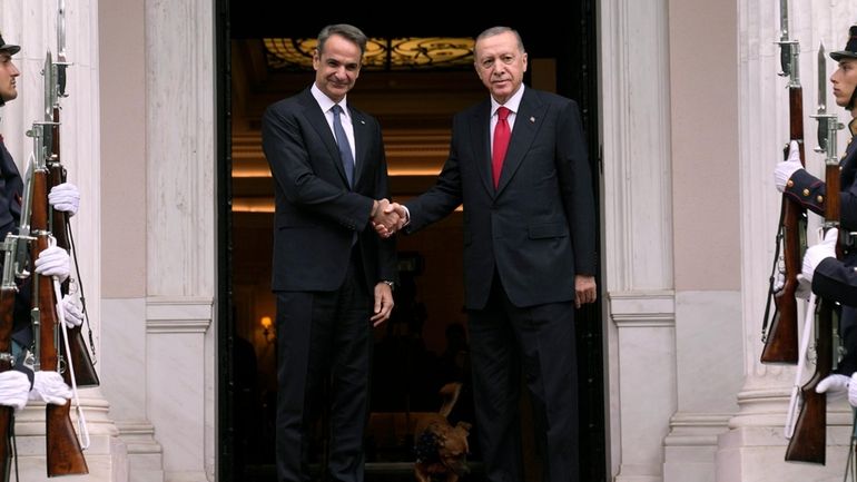 Greece's Prime Minister Kyriakos Mitsotakis, left, welcomes the Turkey's President...