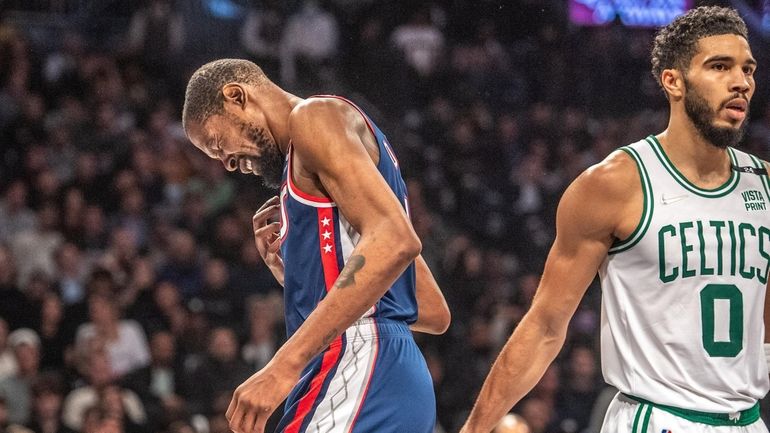 The Nets' Kevin Durant reacts to a foul as the...