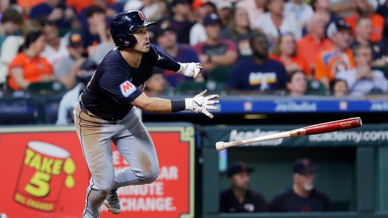 Cleveland Guardians' Steven Kwan tosses his bat as he watches...