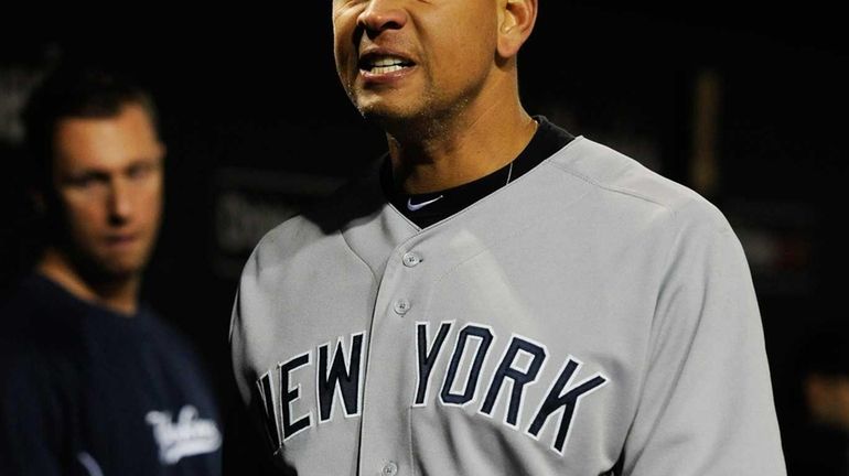 Alex Rodriguez reacts in the dugout after losing Game 2...
