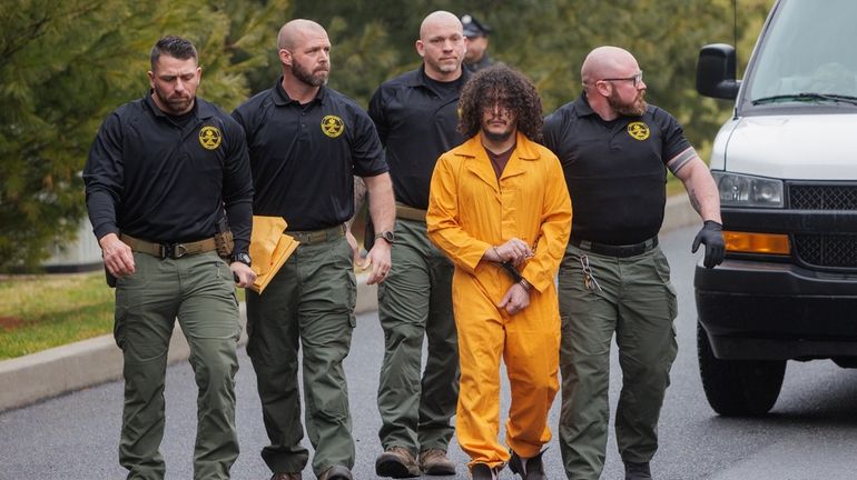 Danilo Cavalcante escorted by officers with the Pennsylvania Department of...