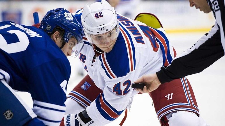 Artem Anisimov faces off against Toronto Maple Leafs player Tyler...