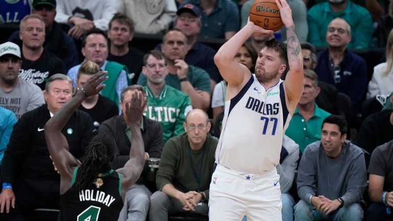 Dallas Mavericks guard Luka Doncic (77) looks to shoot over...