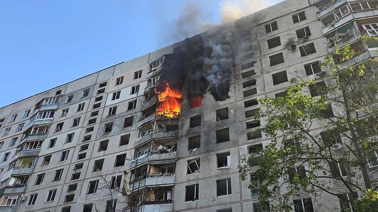 Flames rise after a Russian aerial bomb struck a multi-story...